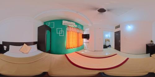 a bedroom with a large bed in a room at manjunatha residency in Chikmagalūr