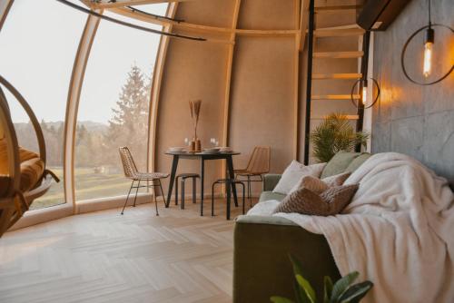 a living room with a couch and a table at AtmoSphere Czorsztyn in Czorsztyn