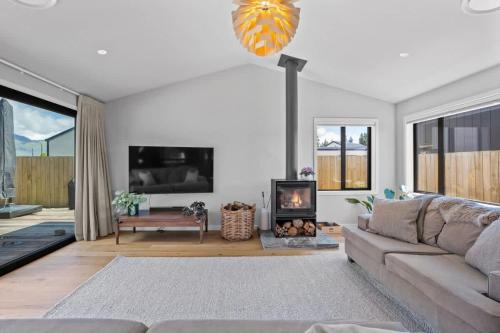 a living room with a couch and a fireplace at Rua Street Escape in Wanaka