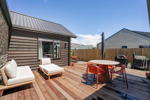a wooden deck with a table and chairs at Rua Street Escape in Wanaka