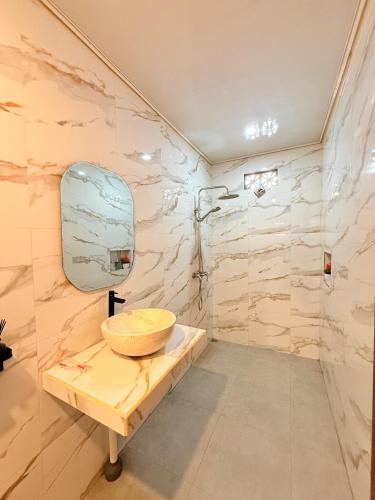 a bathroom with a sink and a mirror at The Angga House in Bangli