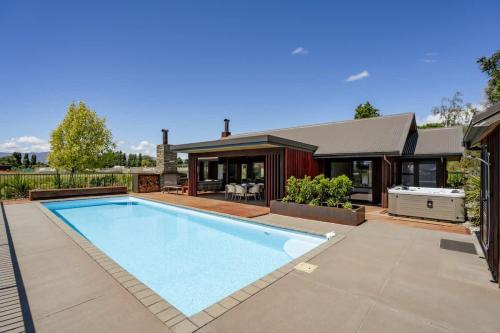 a swimming pool in the backyard of a house at Wanaka Mountain Oasis - Spa & Pool in Wanaka