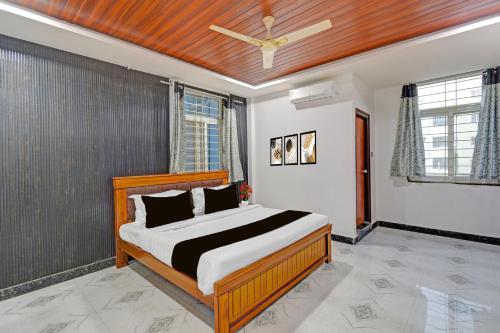 a bedroom with a bed and a ceiling fan at Super Collection O Gachibowli Phase 2 Formerly SK Stays in Gachibowli