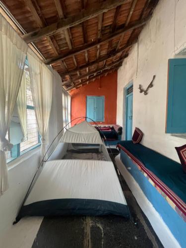 a room with two beds in a room at Peshagar Guest House in Hampi
