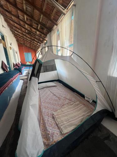 a bunk bed in a room with a mattress at Peshagar Guest House in Hampi