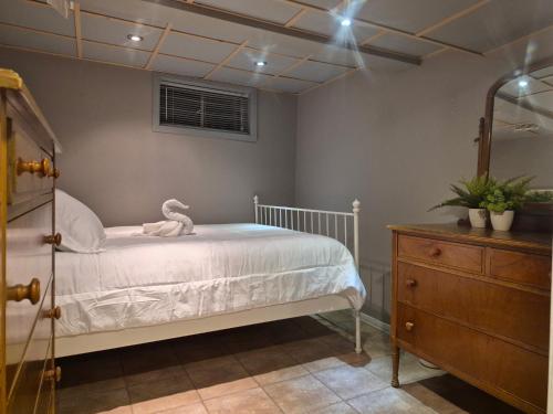 a bedroom with a bed with a teddy bear on it at Guest house in Shawinigan