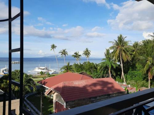 a view of the ocean from the balcony of a resort at Stanley House Seaview Apartments in Panglao Island