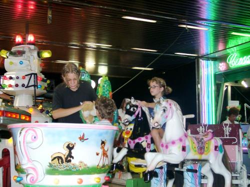 a group of people playing with toy horses at Villetta Botticelli in Lido di Spina