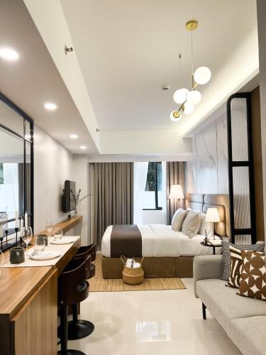 a bedroom with a bed and a living room at Casa De Baguio in Town Center in Baguio