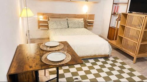 a bedroom with a bed and a table with plates on it at La cassetta 22 in Castelnuovo dellʼAbate