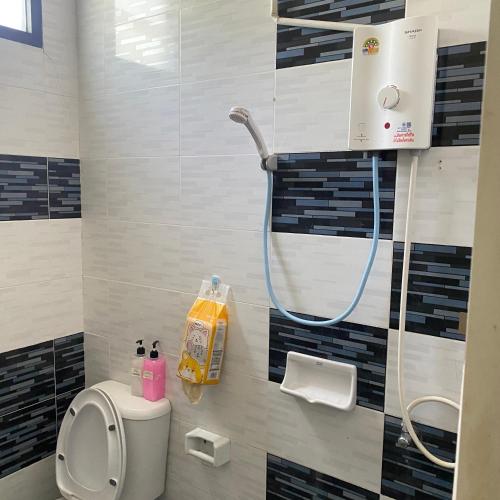 a bathroom with a toilet and a shower at Lucky Villa by Saran in Ban Khlong Chi Lat