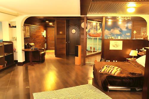 a bedroom with a large bed and a bathroom at The Sky Loft in Kyiv