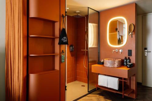 a bathroom with a sink and a shower at Hotel Schani City in Vienna