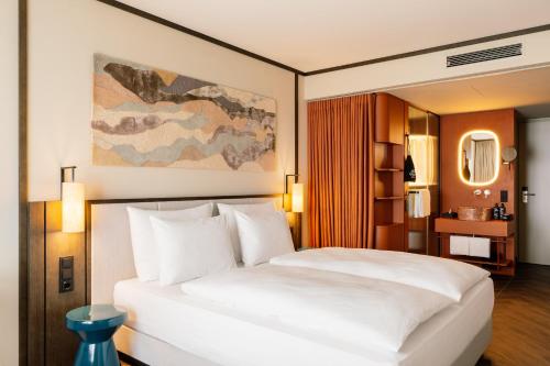 a bedroom with a large white bed in a room at Hotel Schani City in Vienna