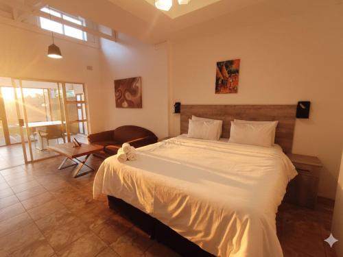a bedroom with a large white bed in a room at Michelangelo - Zur See in Ballito