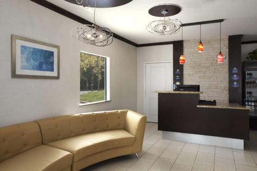 a living room with a couch and a counter at Days Inn & Suites by Wyndham Gonzales TX in Gonzales