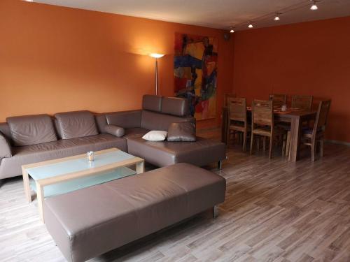 a living room with a couch and a table at Appartment Schlossblick in Wiesenthau