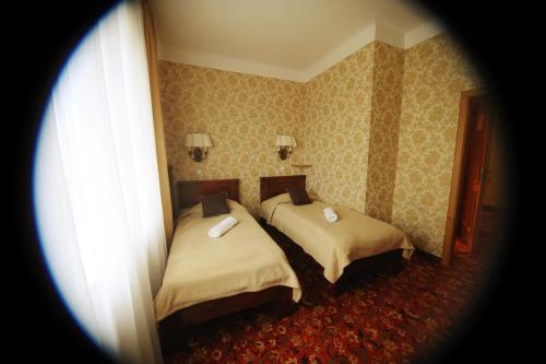 Postel nebo postele na pokoji v ubytování Hotel Plock