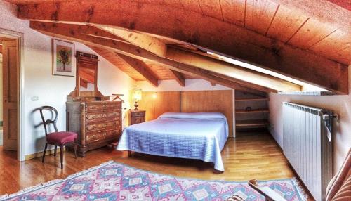 a bedroom with a bed and a wooden ceiling at Anita in Verbania