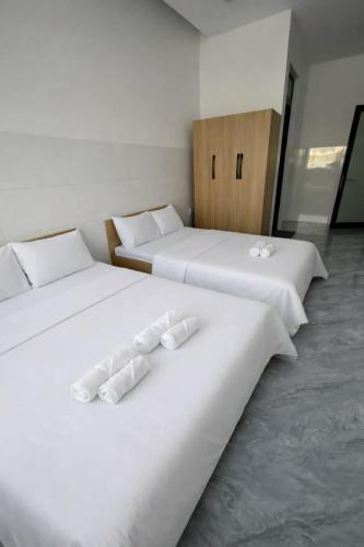 two beds sitting next to each other in a room at Motel Mai Thu in Thăng Bình