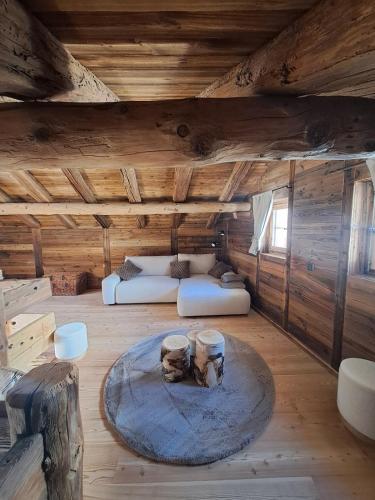 a living room with a couch and a table at Chalet La Grange à Philippe in Evolène