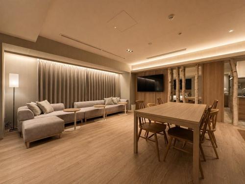a living room with a couch and a table at Randor Hotel Sapporo Heritage in Sapporo