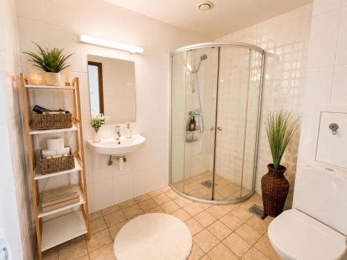 a bathroom with a shower and a toilet and a sink at Panoramic Sea View -13th Floor in Tallinn