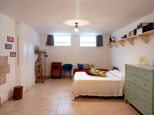 a bedroom with a bed and a dresser in it at Casa Vacanze 9 Cavalieri in Maglie