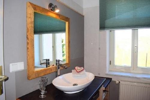 a bathroom with a sink and a mirror at Stadtapartement Geisa in Geisa