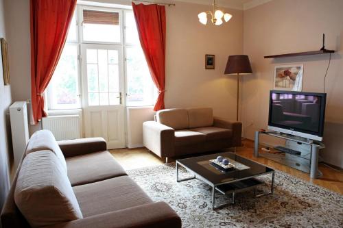 a living room with a couch and a tv at Apartm&aacute;n Moyzesova in Ko&scaron;ice
