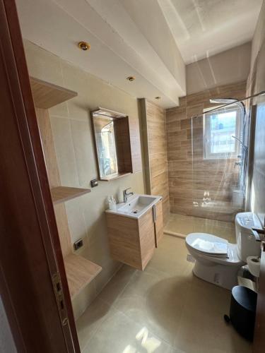 a bathroom with a sink and a toilet at Molos Beach Rooms in Kissamos