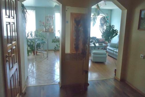 a hallway with a living room with a dining room at Puikus apartamentai in Alytus