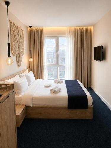 a hotel room with a large bed with a window at Bohem Hotel in Beykoz