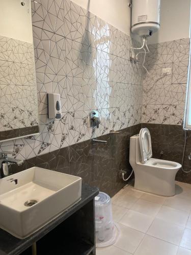a bathroom with a sink and a toilet at BlueWave Villa in Kangra
