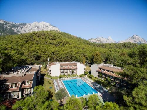 an aerial view of a resort with a swimming pool and mountains at Kimeros Park Holiday Village - Ultra All Inc. Kids Concept in Kemer