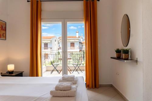 a bedroom with a bed and a large window at Apollo Sea Side Maisonette, Nikiti in Nikiti