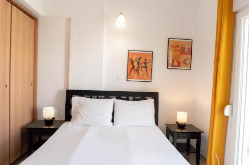 a bedroom with a white bed with two night stands at Apollo Sea Side Maisonette, Nikiti in Nikiti