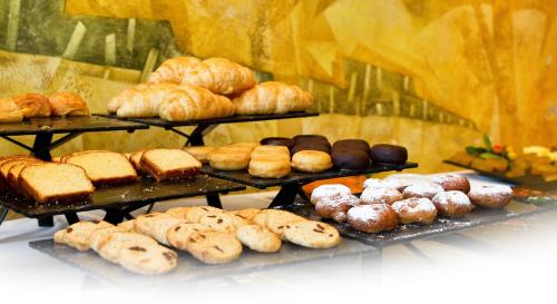 a bunch of different types of bread and pastries at Oca Palacio De La Llorea Hotel & Spa in Deva