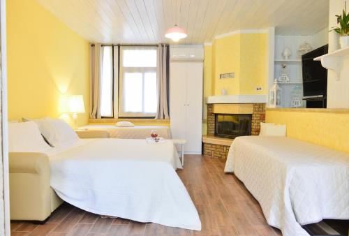 a hotel room with two beds and a fireplace at La Casina - Salento Vacation Rental in San Michele Salentino