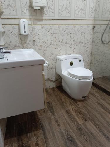 a bathroom with a toilet and a sink at Cameo Villa in Kigali