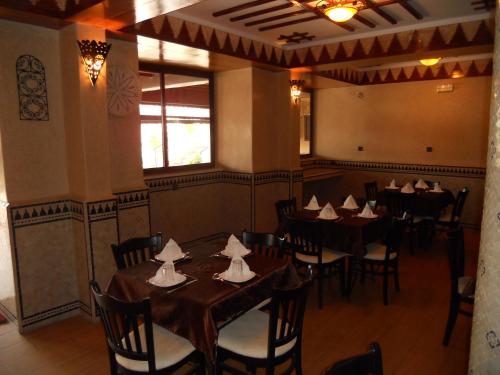 a dining room with tables and chairs in it at Hotel Salama STE SAL- AMA SUD SARL AU in Tafraout