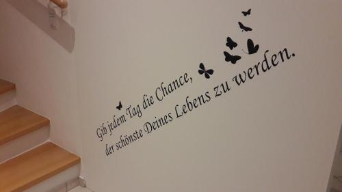 a wall with a staircase with butterflies on it at Chalet Sunnseitn in Radstadt