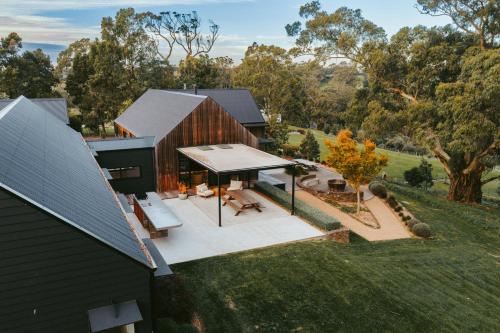 an aerial view of a house with a patio and aestead at Injala House - Designer Masterpiece, Exeter in Exeter