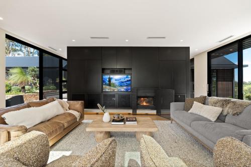 a living room with two couches and a fireplace at Injala House - Designer Masterpiece, Exeter in Exeter