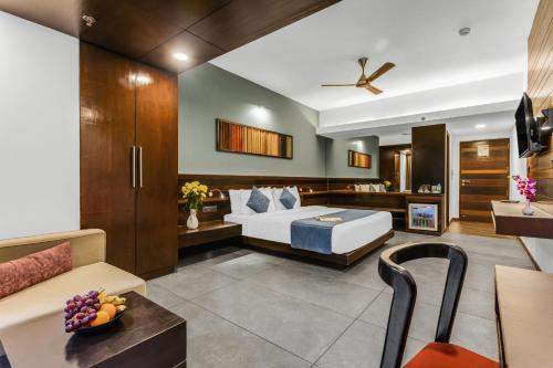 a bedroom with a bed and a living room at SinQ Prive in Candolim