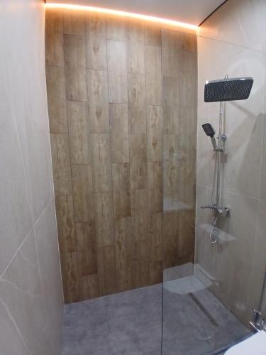 a shower with a glass door in a bathroom at Park Avenue Hotel in Taraz