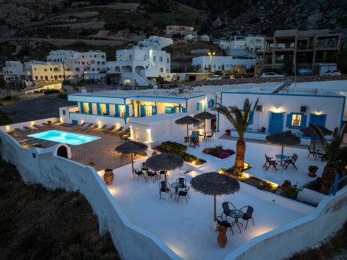 an aerial view of a villa with a pool at night at Ancient Thera Apartments in Kamari