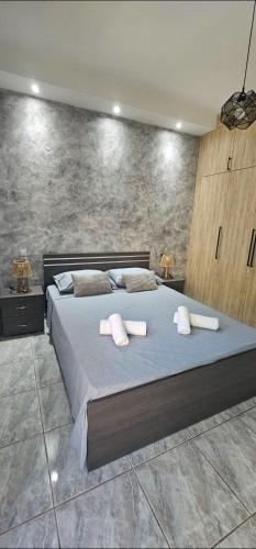 a bedroom with a large bed with two pillows on it at Alma-Librehouse in Kefalos