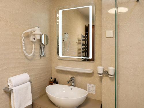 a bathroom with a sink and a mirror at Hotel Kadmo by Aycon in Budva