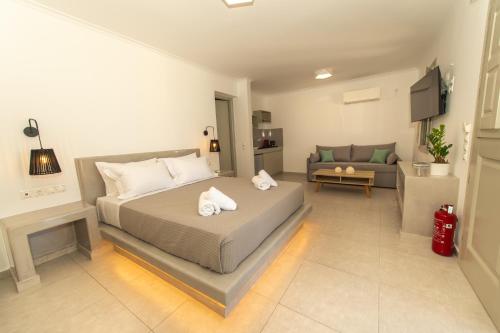 a bedroom with a bed and a living room at Agia Marina Caldera suites in Megalochori